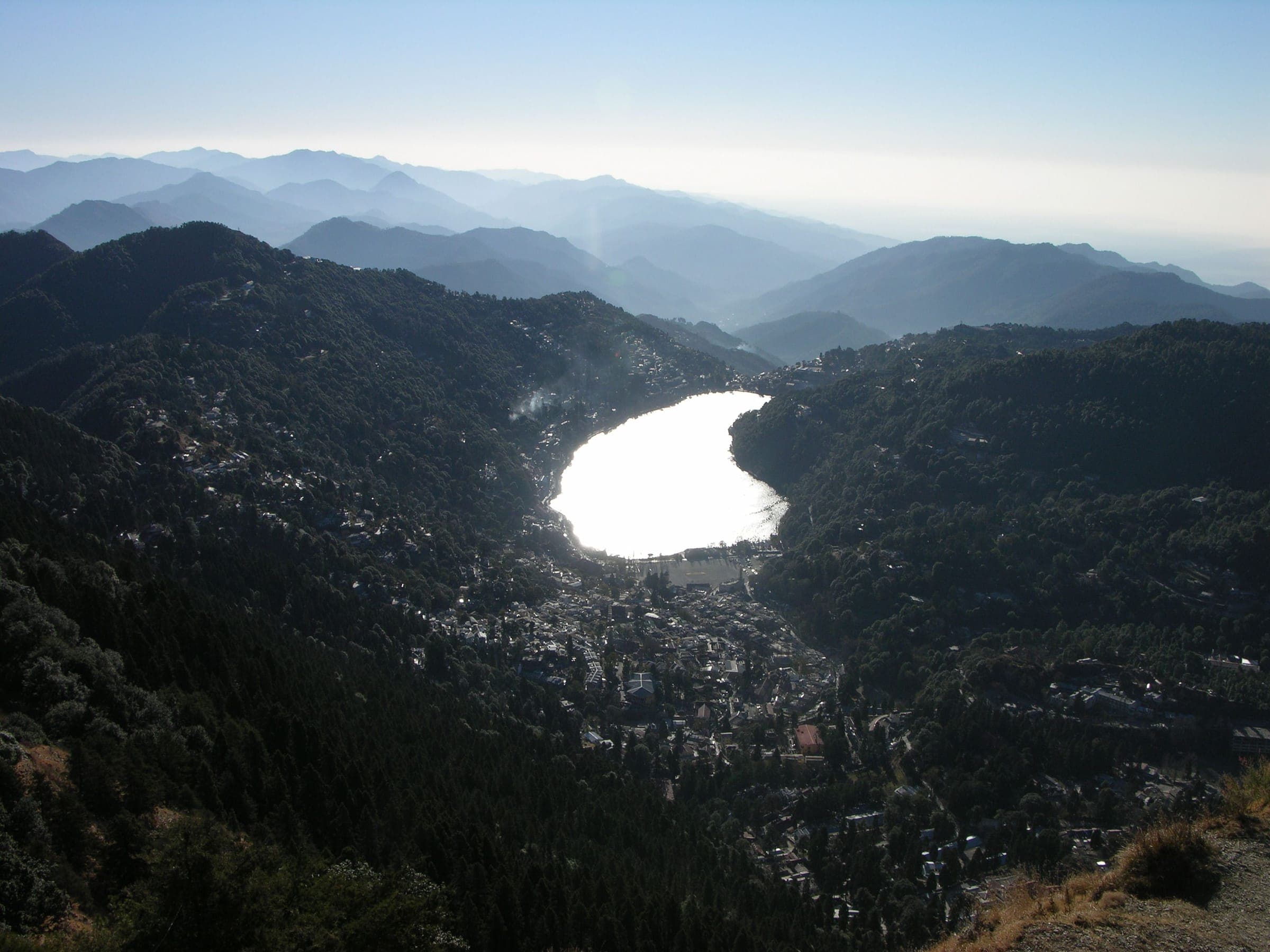 Naini Lake seen from high above, ringed by the forested hills of Nainital