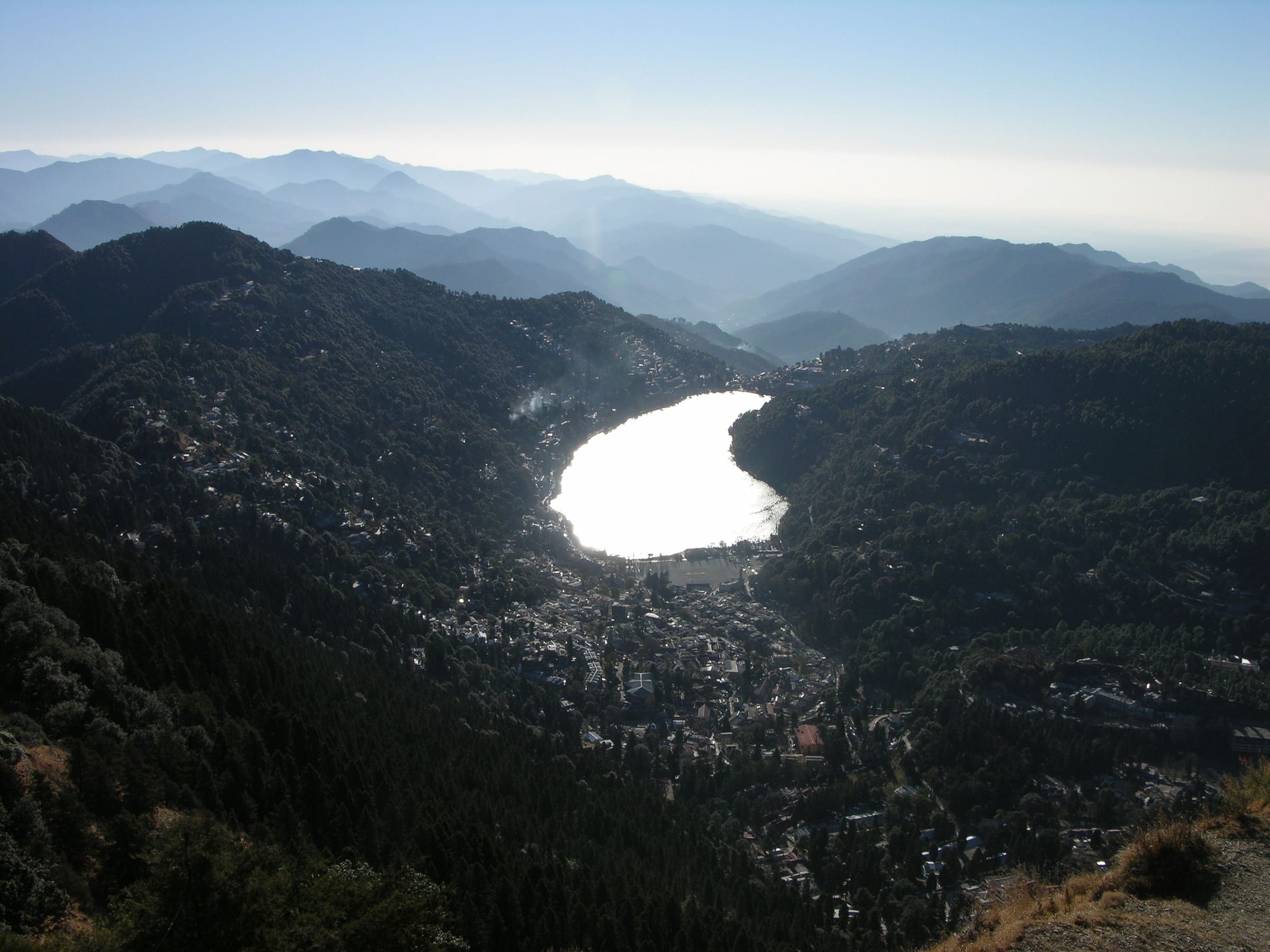 Naini Lake seen from high above, ringed by the forested hills of Nainital